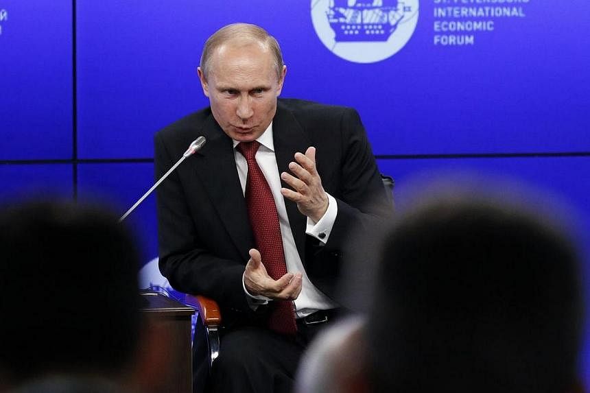 Russia's President Vladimir Putin speaks during a session of the St. Petersburg International Economic Forum 2014 in St Petersburg on May 23, 2014.&nbsp;Mr Putin said on Friday that the crisis in Ukraine had evolved into a full-scale civil war, blami