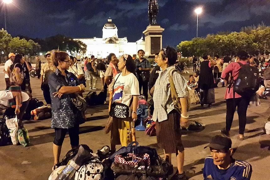 Anti-government protesters waiting on Thursday night at the Royal Plaza in inner Bangkok for buses arranged by the military to send them back home to various provinces. - PHOTO:&nbsp;TAN HUI YEE