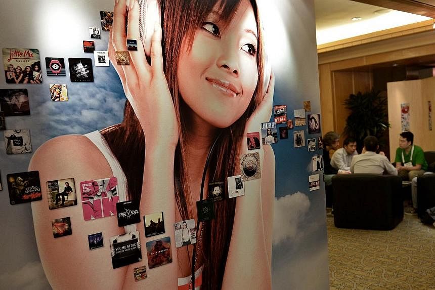 People sit at a booth during the Music Matters conference in Singapore on May 22, 2014. Music Matters, an annual music conference and live music festival, returns with a line-up of more than 60 bands from 18 places performing over four days.&nbsp;-- 