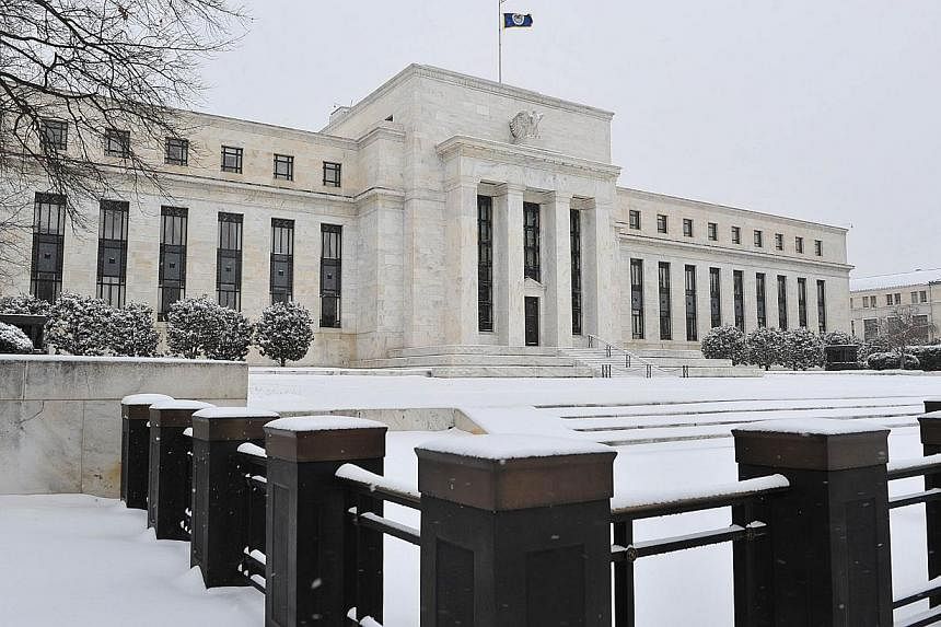 The US Federal Reserve is seen during a snow storm in in Washington, DC on March 3, 2014. After years of pulling out the stops to boost a stubbornly sluggish US economy, the Federal Reserve is moving back to "normal" monetary policy, a top Fed offici