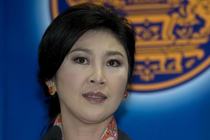 Thailand's former prime minister Yingluck Shinawatra reported to the kingdom's military junta on Friday, an aide said. -- PHOTO: AFP