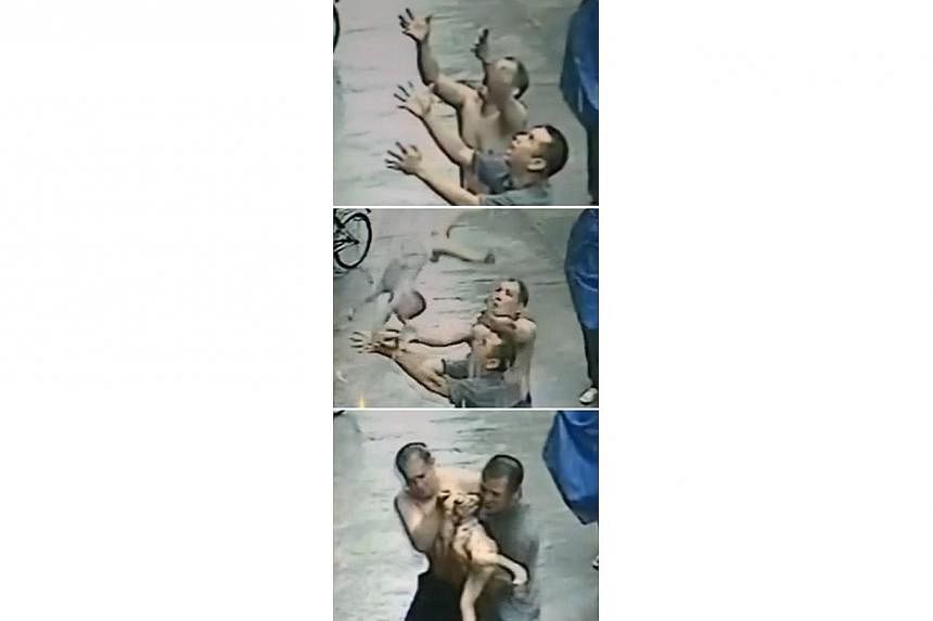 This combination of three screen grabs taken from CCTV footage on May 18, 2014 shows (from top to bottom) two men reaching out with their hands as they prepare to succesfully catch a one-year-old baby falling from a window in the Xiaolan township of 