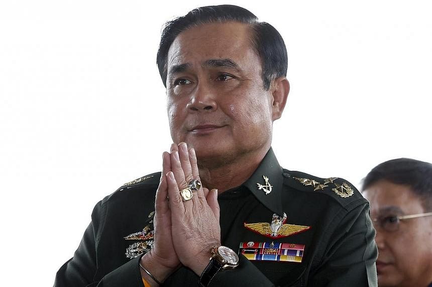 Thai army chief General Prayuth Chan-ocha gives a traditional greeting as he arrives for a meeting at the Army Club in Bangkok, Thailand on May 20, 2014. -- PHOTO: EPA