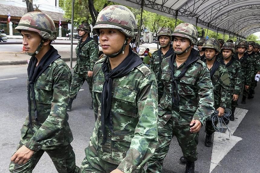 Soldiers march near the Government House after anti-government protesters were removed off the site following the coup being declared in Bangkok, Thailand on May 23, 2014. -- PHOTO: EPA