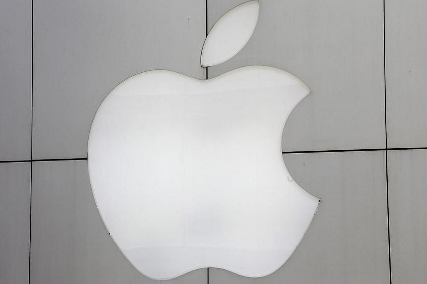 The logo of Apple Inc. is seen on the wall of an Apple Store in Tokyo, Japan, on 16 May 2014. -- PHOTO: EPA