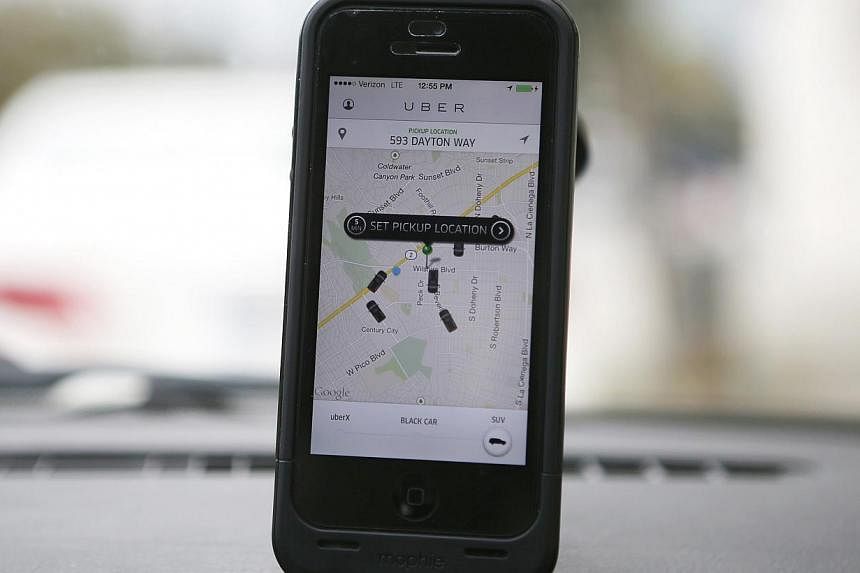 An Uber app is seen on an iPhone in Beverly Hills, California on Dec 19, 2013. -- PHOTO: REUTERS