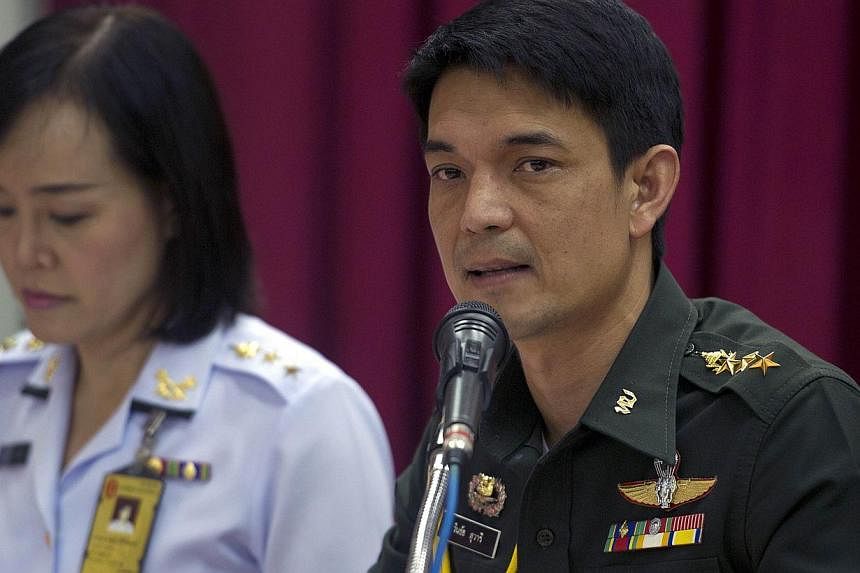 Thai deputy army spokesman Colonel Winthai Suwari (right) speaks during a press conference at Army Club in Bangkok on May 24, 2014. -- PHOTO: AFP
