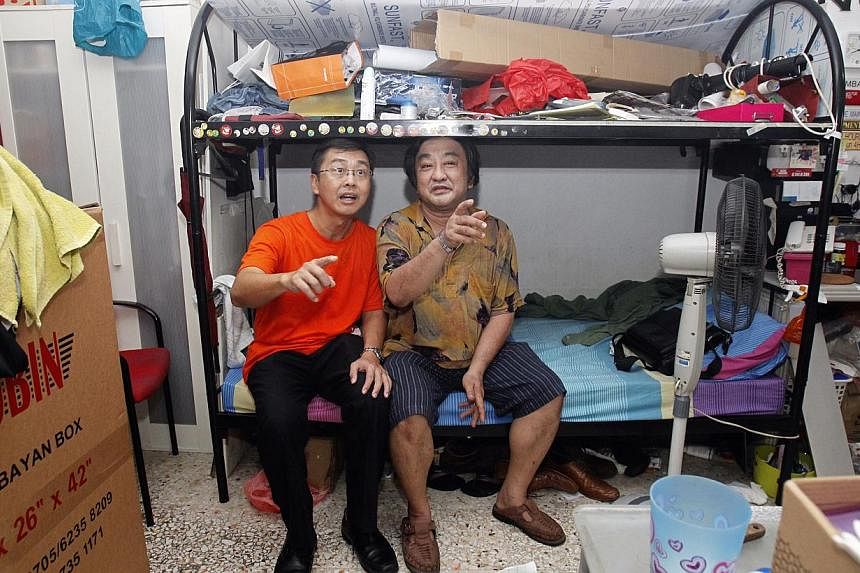 National Council of Social Service chief Sim Gim Guan (left) chatting with a resident while distributing hampers to low-income families last week. The statutory board will have a central system to recruit and train social service leaders.