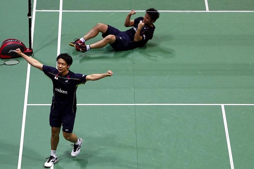 Japan's Hiroyuki Endo (L) and Kenichi Hayakawa celebrate after they defeated Malaysia's Tan Boon Heong and Hoon Thien How in the men's doubles final match in the Thomas Cup badminton championship in New Delhi May 25, 2014. -- PHOTO: REUTERS