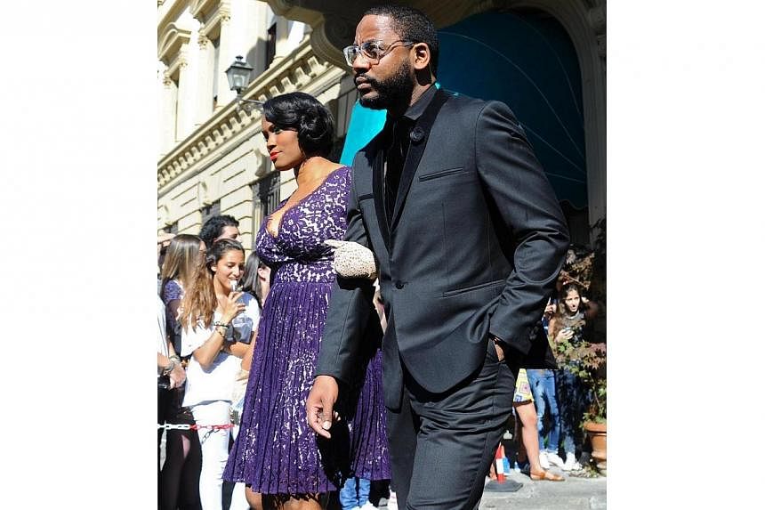 Unidentified guests walk out of the hotel for the wedding of Kim Kardashian and Kanye West in Florence, Italy, on May 24, 2014. -- PHOTO: EPA