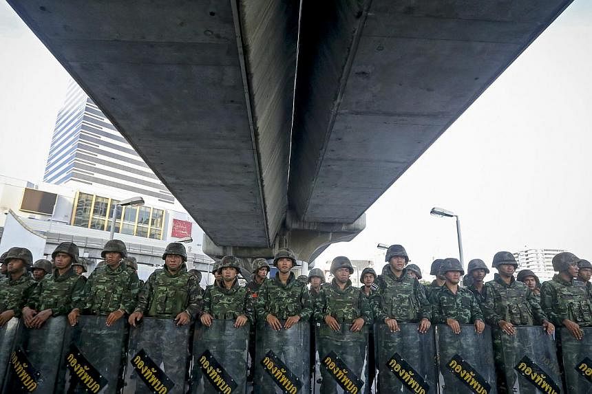 Thai soldiers block access to a section of an overpass during a protest against the military coup in Bangkok, Thailand, on May 24, 2014. - PHOTO: AFP