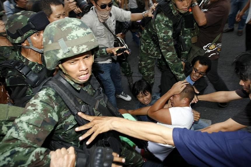 Thai soldiers confronting demonstrators during a protest against the coup near the Victory Monument in Bangkok, Thailand, on May 24, 2014. - PHOTO: EPA