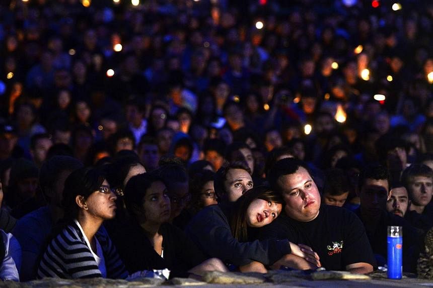 Students gathered for a candlelight vigil on the University of California Santa Barbara campus on May 24, 2014 to remember those killed during a rampage by lone gunman Elliot Rodger in nearby Isla Vista. -- PHOTO: AFP