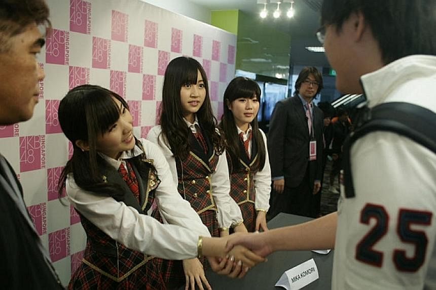 (From left) Japanese pop group AKB48’s Misaki Iwasa, Mika Komori and Miho Miyazaki met fans on May 14, 2011, and also performed at *Scape on the next day. -- PHOTO: AKB48 Singapore