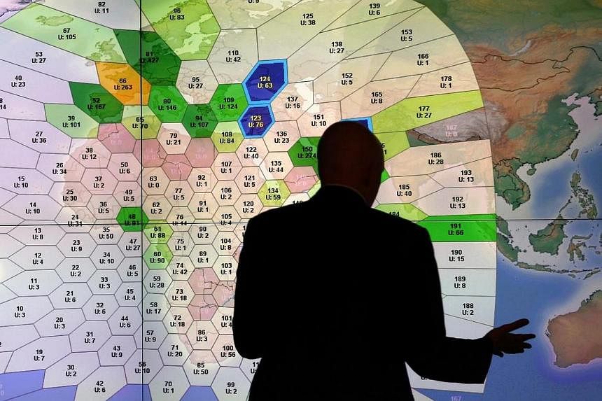 A member of staff at satellite communications company Inmarsat works in front of a screen showing subscribers using their service throughout the world, at their headquarters in London on March 25, 2014.&nbsp;&nbsp;Major airlines want real-time tracki