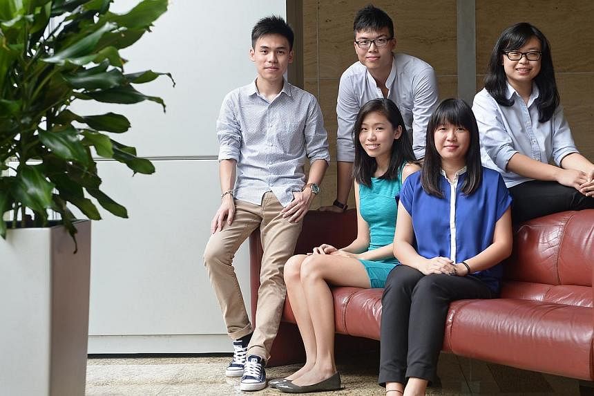 (Seated, from left) Singapore Polytechnic (SP) graduate Janna Wong, 21, and Temasek Poly (TP) graduate Samantha Lek, 20, will be studying law at NUS, while (back row, from left) SP graduate Raphael Ng, TP graduate Joshua Teo and Ngee Ann Polytechnic 