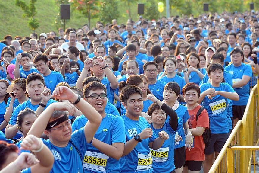 Runners warming up before the 5km fun run at the Straits Times Run in the Park at Punggol Waterway last year. This year's ST Run at the Hub will allow participants to be the first to finish at the new National Stadium.