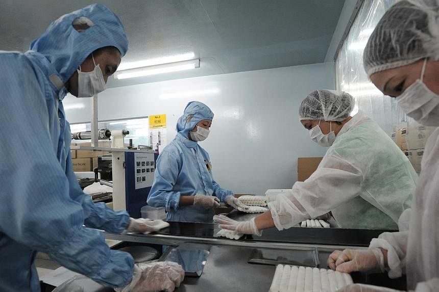 Factory workers for Freshening Industries packing wet wipes at the company's factory in Loyang. -- FILE PHOTO: ST