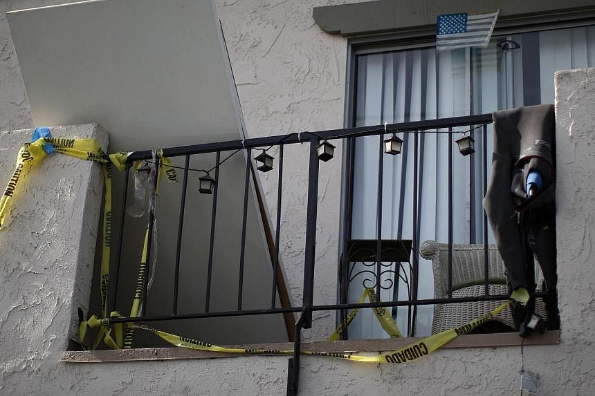 Crime scene tape hangs from an apartment balcony at a shooting site on Del Playa Drive on May 25, 2014 in Isla Vista, California. -- PHOTO: AFP