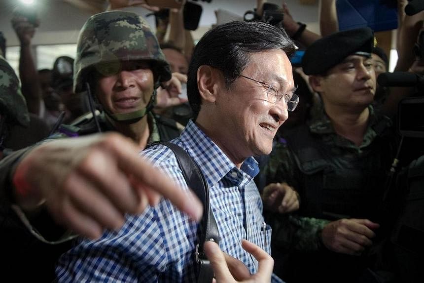 Chaturon Chaisang, former education minister in the government ousted by the military last week is arrested by Thai soldiers at the FCCT (Foreign Corespondent Club in Thailand) in Bangkok on May 27, 2014. -- PHOTO: AFP