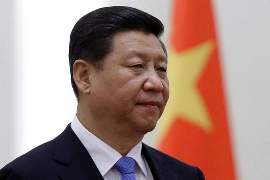 China's President Xi Jinping stands next to a Chinese national flag during a welcoming ceremony at the Great Hall of the People in Beijing on Nov 13, 2013.&nbsp;Chinese President Xi Jinping has chosen "repression over reform" as clampdowns precede th