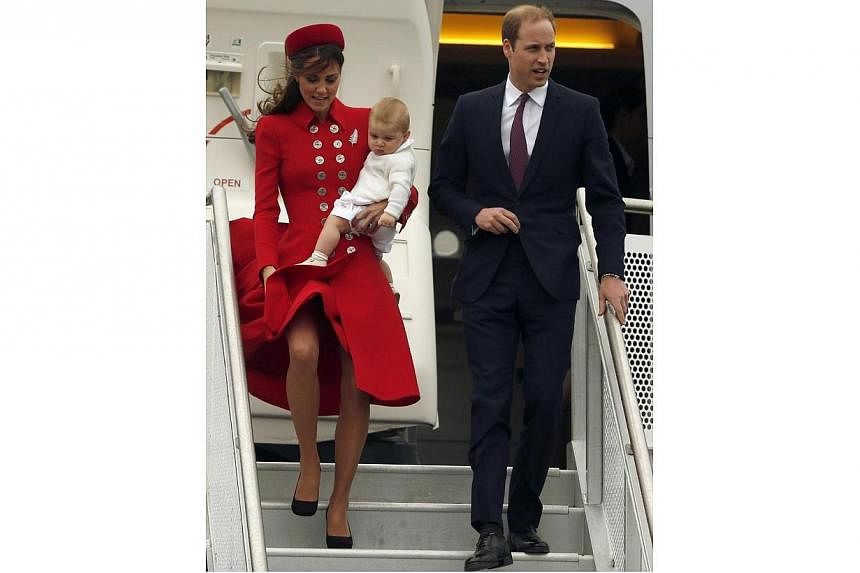 Britain's Prince William, his wife Catherine, Duchess of Cambridge and their son Prince George disembark from their plane after arriving in Wellington on April 7, 2014.&nbsp;The Duchess of Cambridge has suffered a couple of embarassing wardrobe malfu