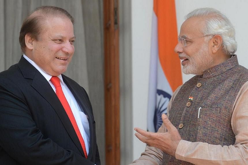 India's newly sworn-in Prime Minister Narendra Modi (right) talks with Pakistani Prime Minister Nawaz Sharif as they shake hands during a meeting in New Delhi on May 27, 2014. Mr Modi told Mr Sharif that Pakistan must prevent militants from using its