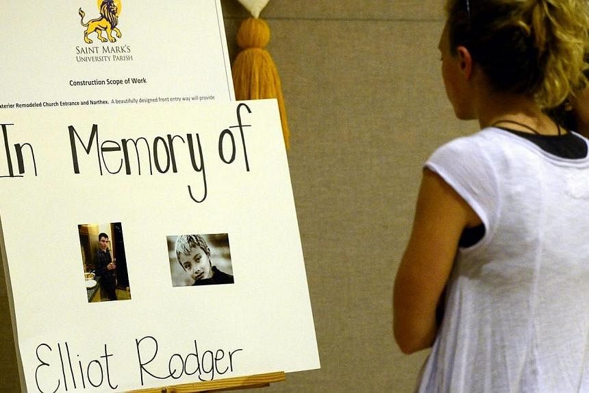 A woman looks at a placard showing pictures of 22-year old shooter Elliot Rodger following a service at St. Mark's University Parish in the college town of Isla Vista, California, USA on May 25, 2014.&nbsp;The 22-year-old who went on a rampage in Cal