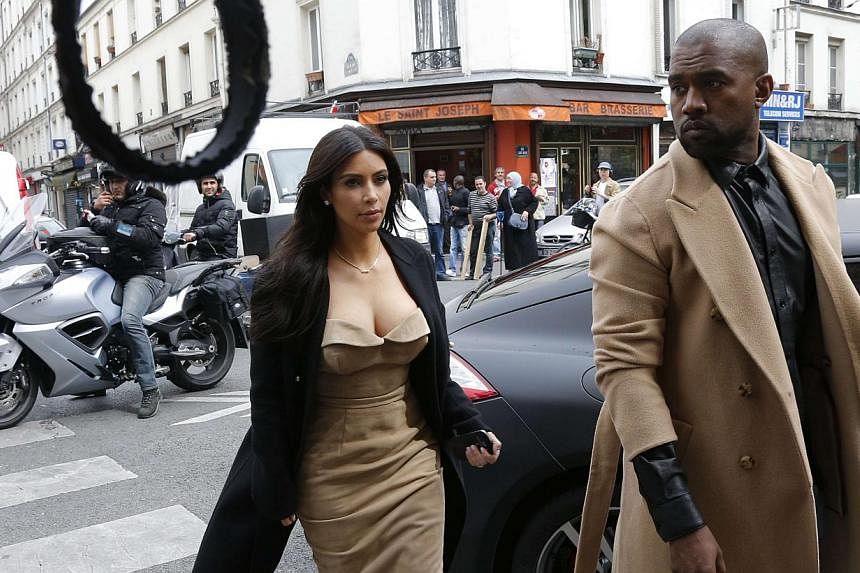 TV personality Kim Kardashian (left) and rapper Kanye West arrive at a fashion designer workshop in Paris on May 21, 2014. -- PHOTO: REUTERS