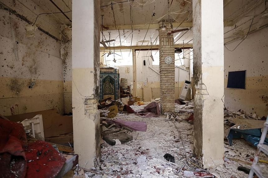 Debris lies strewn at the site of a bomb attack inside a Shi'ite mosque in Baghdad on May 27, 2014.&nbsp;A suicide bomber blew himself up inside a Shi'ite mosque in central Baghdad on Tuesday, killing at least 19 people, security and medical sources 