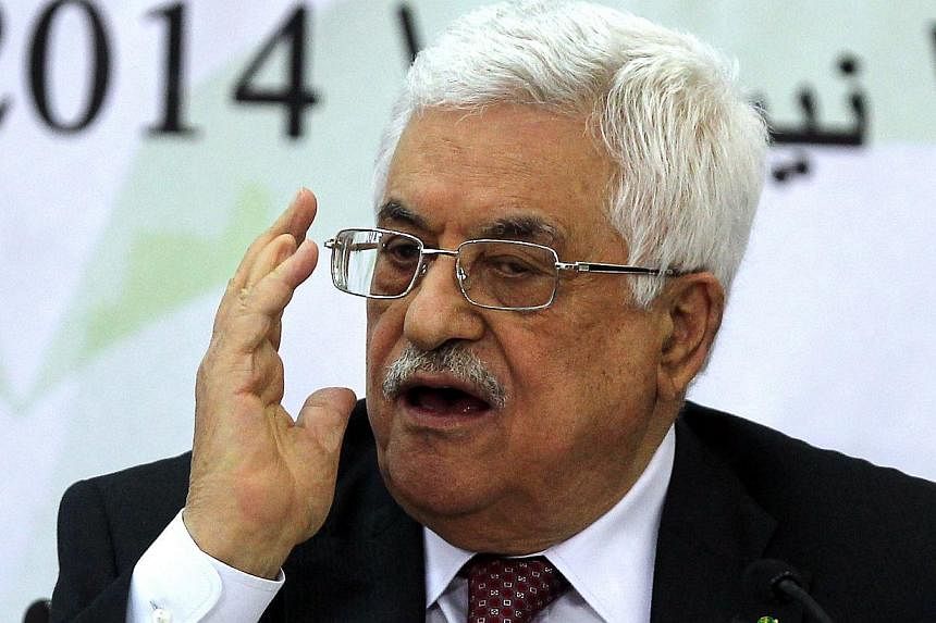 Palestinian Authority President Mahmud Abbas gestures as he attends a meeting of Palestinian businessmen from East Jerusalem, at the Palestinian Authority headquarters in the West Bank city of Ramallah, on April 29, 2014. Mr Abbas will unveil a unity