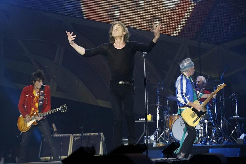 Mick Jagger (second left), front man of the British rock band the Rolling Stones, performs on stage with fellow band members Ronnie Wood (left) on guitar, Charlie Watts (right) on drums and Keith Richards (second right) on guitar during a concert in 