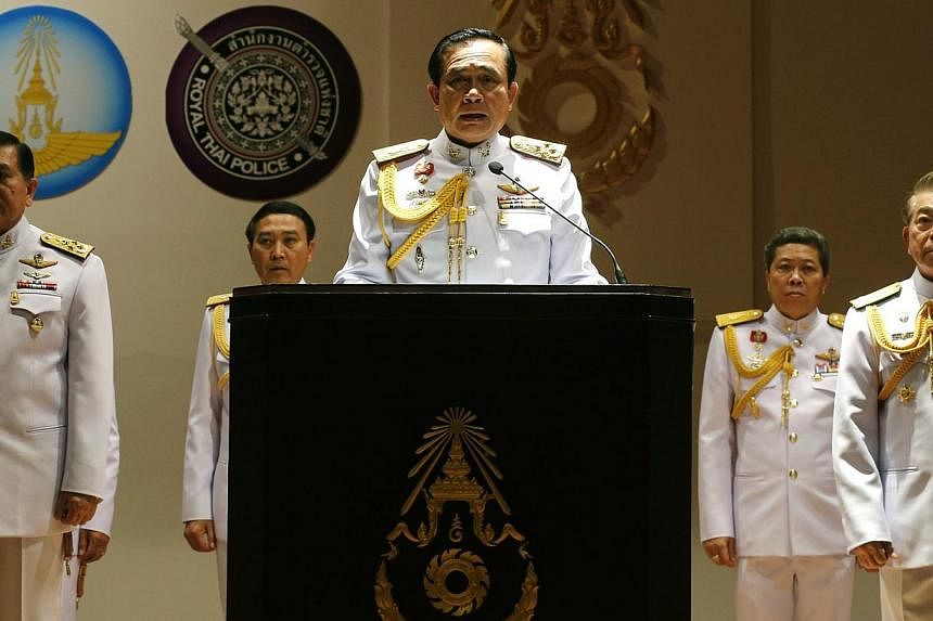 Thai army chief and junta head General Prayuth Chan-ocha (centre) speaks to journalists during a news conference at the Royal Thai Army headquarters in Bangkok, Thailand, on May 26, 2014. -- PHOTO: EPA