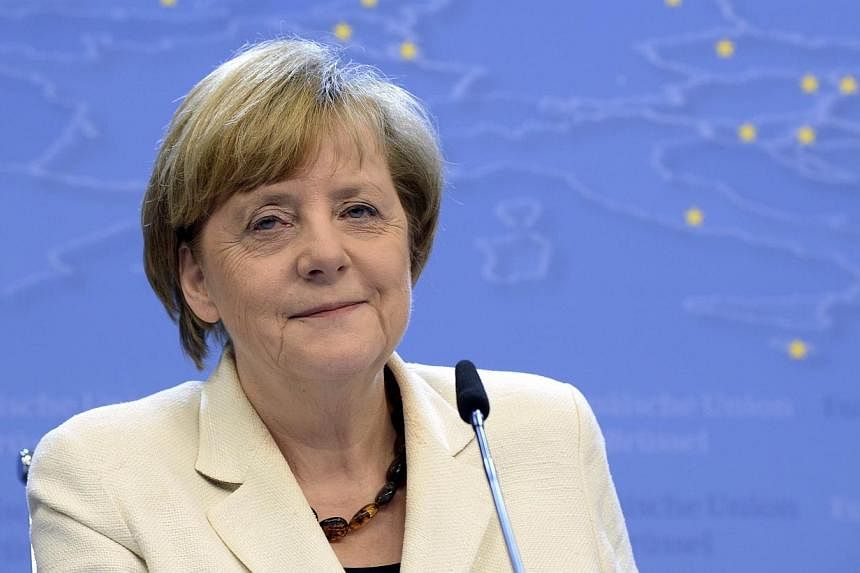 German Chancellor Angela Merkel talks to the media following an informal dinner of European Union heads of state or government at the EU Council in Brussels on May 27, 2014.&nbsp;Merkel topped Forbes's list of the world's most powerful women for the 