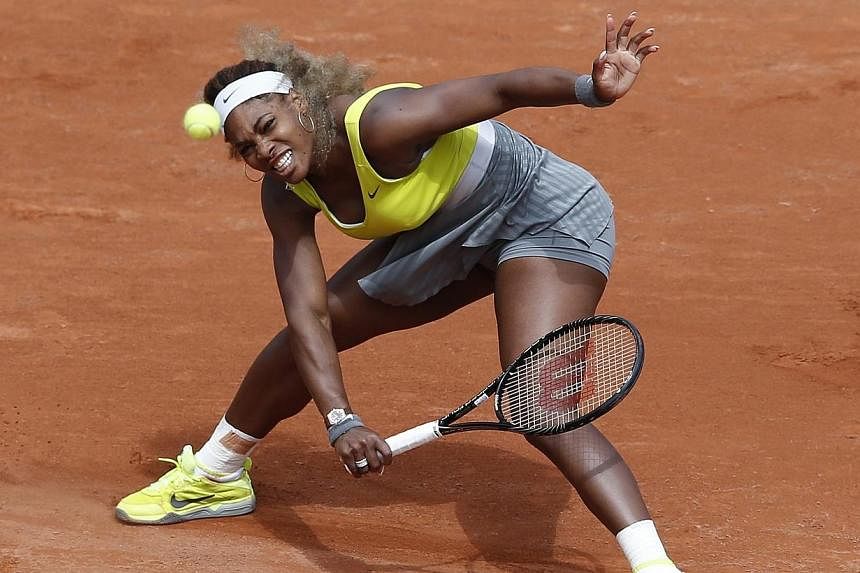 Serena Williams of USA returns to Garbine Muguruza of Spain during their second round match for the French Open tennis tournament at Roland Garros in Paris, France on May 28, 2014.&nbsp;Defending women's singles champion Serena Williams was sensation