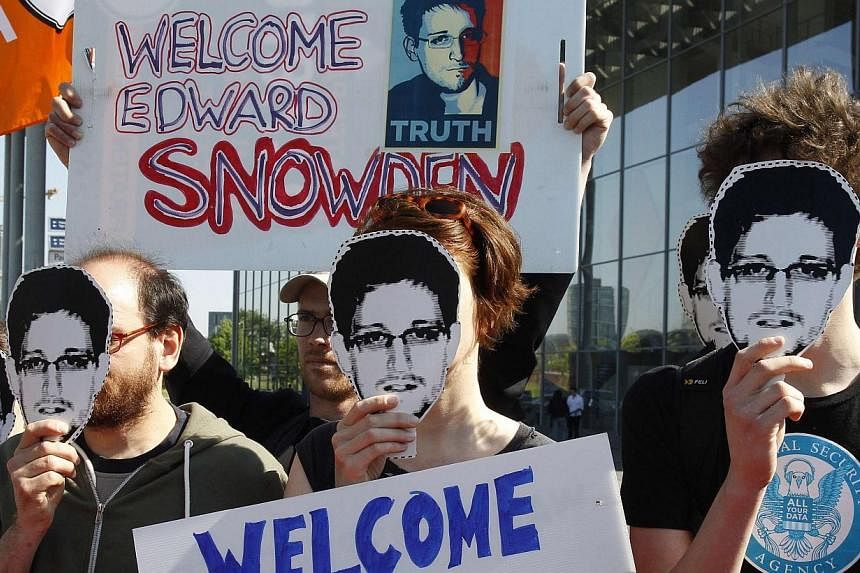 Protesters hold masks depicting former U.S. National Security Agency contractor Edward Snowden during a demonstration in Berlin on May 22, 2014.&nbsp;Secretary of State John Kerry on Wednesday, May 28, 2014, said fugitive intelligence leaker Edward S