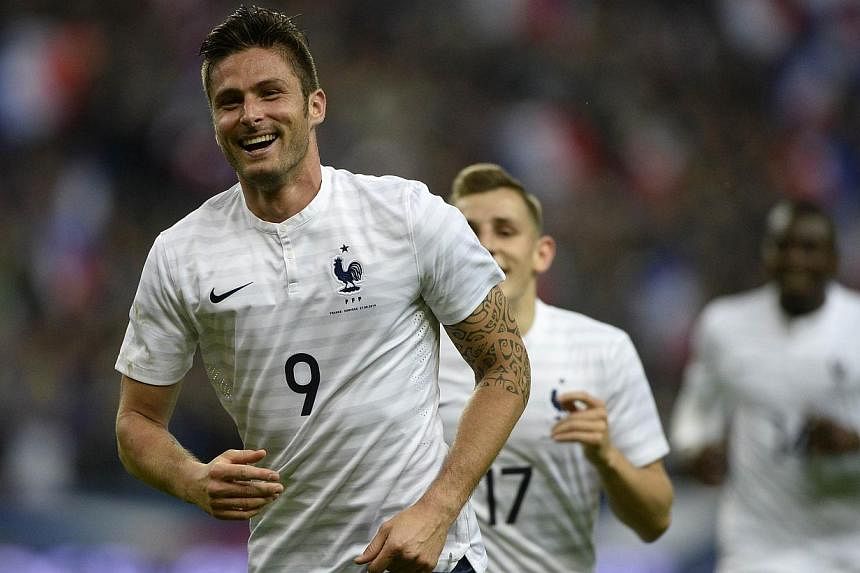France's forward Olivier Giroud gestures as he celebrates the scoring of a goal during a friendly football match between France and Norway at the Stade de France in Saint-Denis near Paris, on May 27, 2014, ahead of the 2014 FIFA World Cup football to