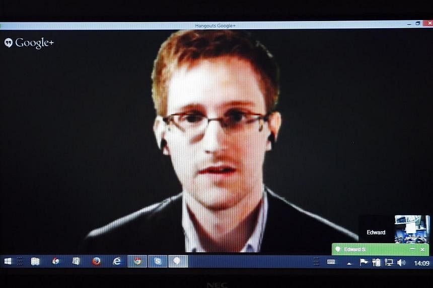 Accused United States government whistle-blower Edward Snowden is seen on a screen as he speaks via video conference with members of the Committee on Legal Affairs and Human Rights of the Council of Europe's Parliamentary Assembly during a hearing on