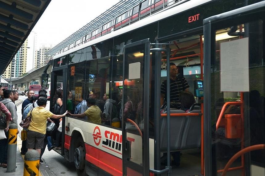 Commuters boarding a bus at the bus stop next to Clementi MRT along Clementi West Avenue on Jan 17, 2014.&nbsp;The first bus service package to be tendered out under a new operating model will comprise 24 existing routes in the western part of the is