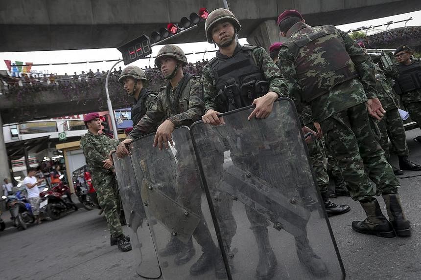 Thai soldiers stand guard during a protest against the military coup at the victory monument in Bangkok, Thailand on May 27, 2014. &nbsp;-- PHOTO: EPA