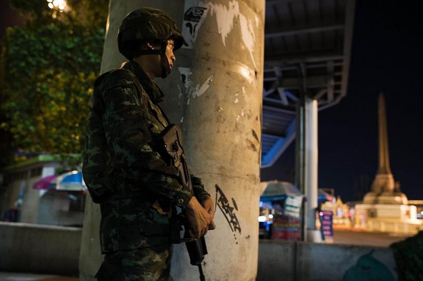 A Thai soldier stands guard during a curfew imposed by the Thai army at Victory monument in Bangkok on May 25, 2014. -- PHOTO: AFP&nbsp;