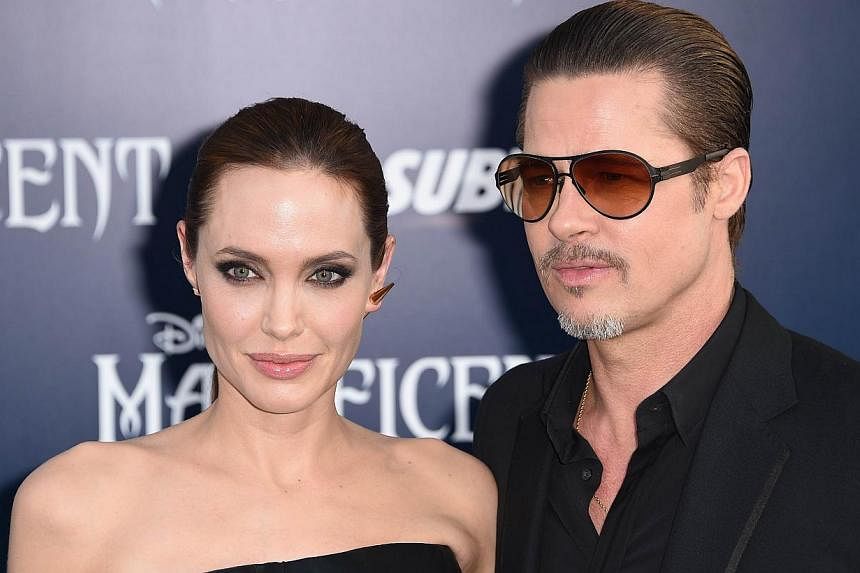 Angelina Jolie and Brad Pitt arrive for the world premiere of Disney's Maleficent at El Capitan Theatre in Hollywood, California. on May 28, 2014. -- PHOTO: AFP