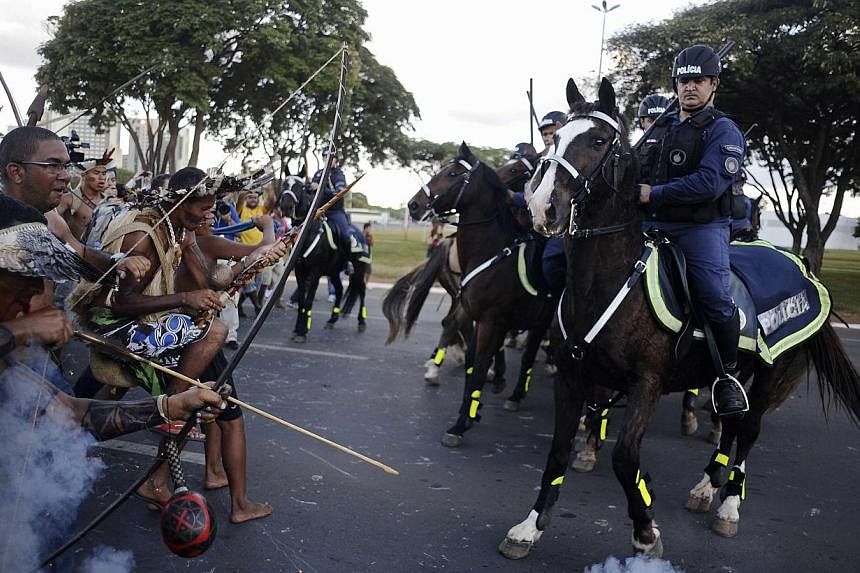 Police use tear gas to impede native Brazilians from marching towards the Mane Garrincha soccer stadium during a demonstration in Brasilia, on May 27, 2014. -- PHOTO: REUTERS