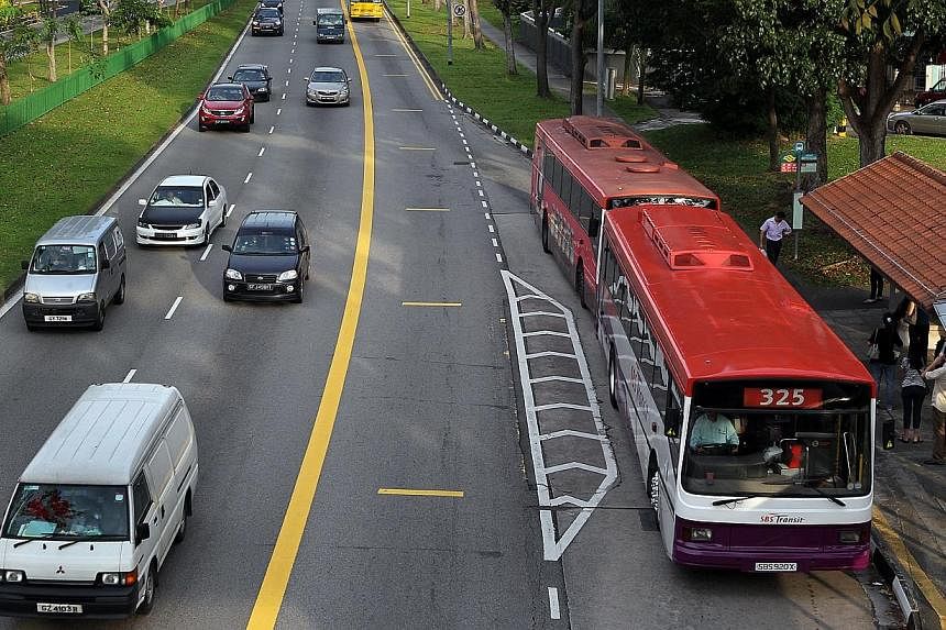 Motorists steering clear of the bus lane at Hougang Avenue 2 during bus lane operating hours. Video cameras are being installed on all new buses to keep check on the road in front.&nbsp;-- PHOTO: ST FILE
