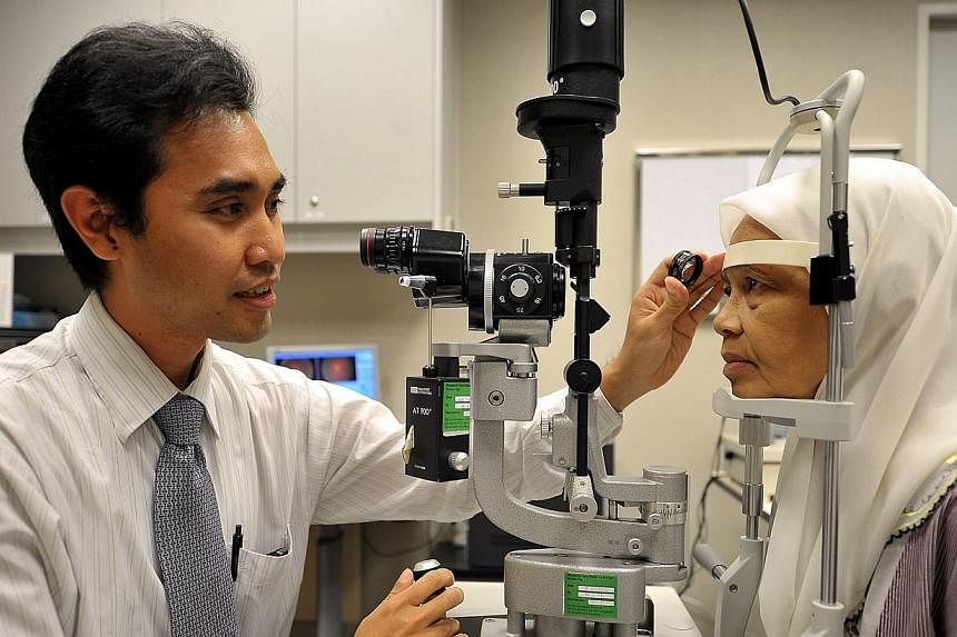 Dr Ainur Rahman Anuar, a clinical research fellow at the Singapore Eye Research Institute (Seri), checking the eyes of a patient using a "slit lamp" at the Singapore National Eye Centre (SNEC) on Feb 17, 2012.&nbsp;The Singapore National Eye Centre (