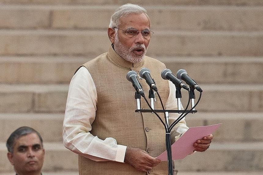 Narendra Modi takes the oath of office as India's new Prime Minister in New Delhi&nbsp;on May 26, 2014.&nbsp;Indian Prime Minister Narendra Modi invited Chinese President Xi Jinping on Thursday, May 29, 2014, to visit, seeking greater engagement betw
