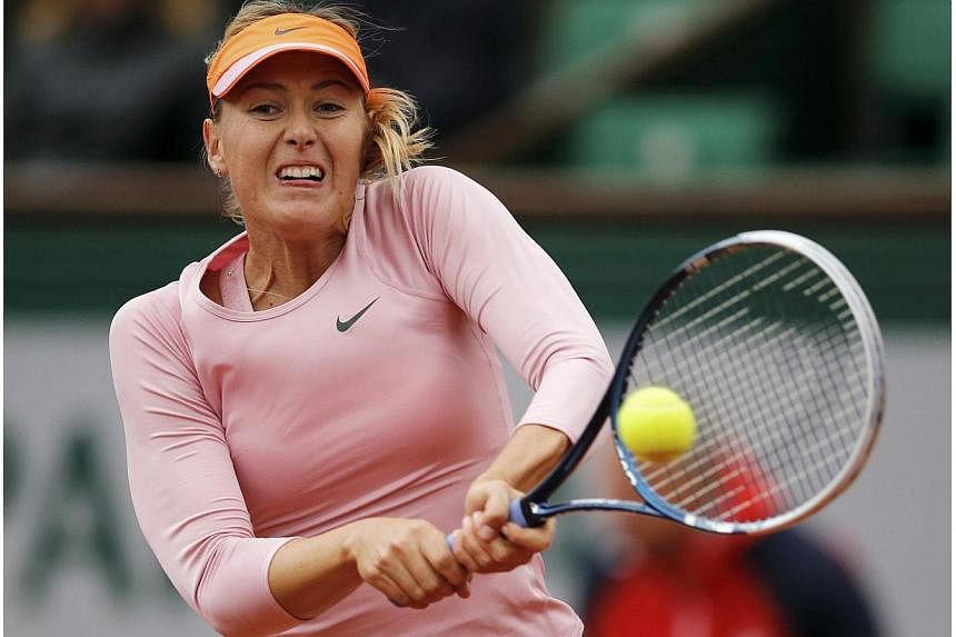 Maria Sharapova of Russia returns a backhand to Tsvetana Pironkova of Bulgaria during their women's singles match at the French Open tennis tournament at the Roland Garros stadium in Paris on May 28, 2014. -- PHOTO: REUTERS