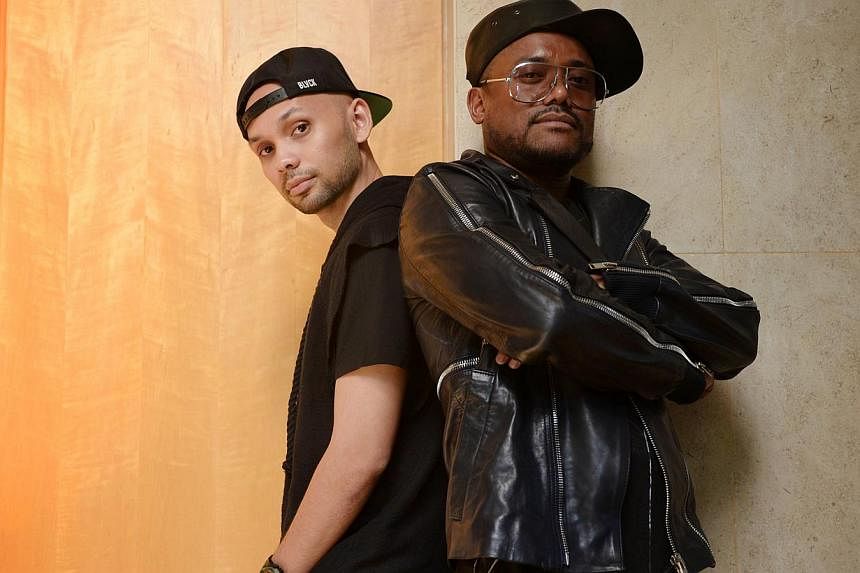 Singapore rapper Kevin Lester (left) with apl.de.ap from The Black Eyed Peas, who has set up a new South-east Asian-based label and signed on three artists so far, including Lester. -- ST PHOTO: MARK CHEONG