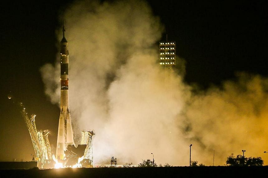 The Soyuz TMA-13M rocket is launched with Expedition 40 Soyuz Commander Maxim Suraev, of the Russian Federal Space Agency, Roscosmos, Flight Engineer Alexander Gerst, of the European Space Agency, ESA, and Flight Engineer Reid Wiseman of NASA from th