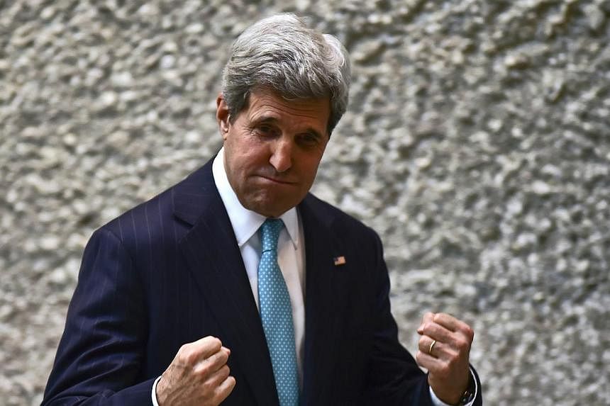 US Secretary of State John Kerry gestures after a conference in the framework of the Cleantech Challenge Mexico 2014, in Mexico City, on May 21, 2014. Mr Kerry lashed out at fugitive Edward Snowden on Wednesday, urging him to man-up and do his patrio
